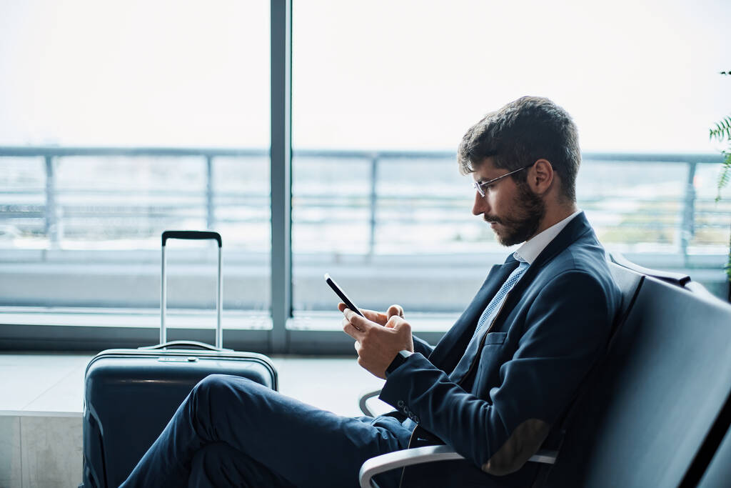 business man using a digital tablet while waiting for his flight. photo with a copy-space.