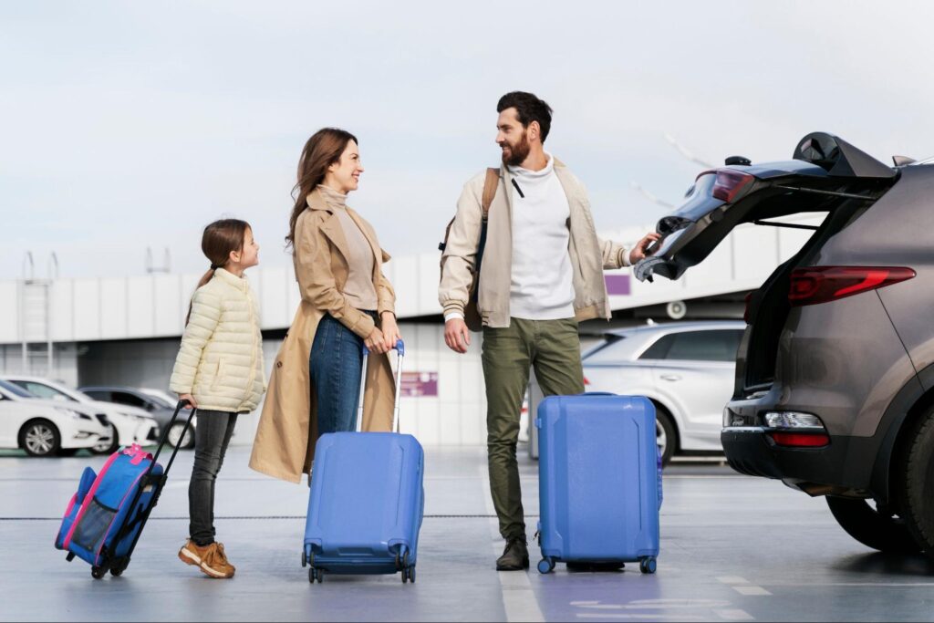 Full shot of a couple traveling with a kid holding luggage