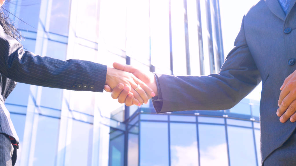 Close up businesswoman and businessman shaking hands