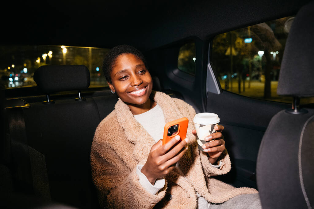 Woman using her smartphone while drinking coffee