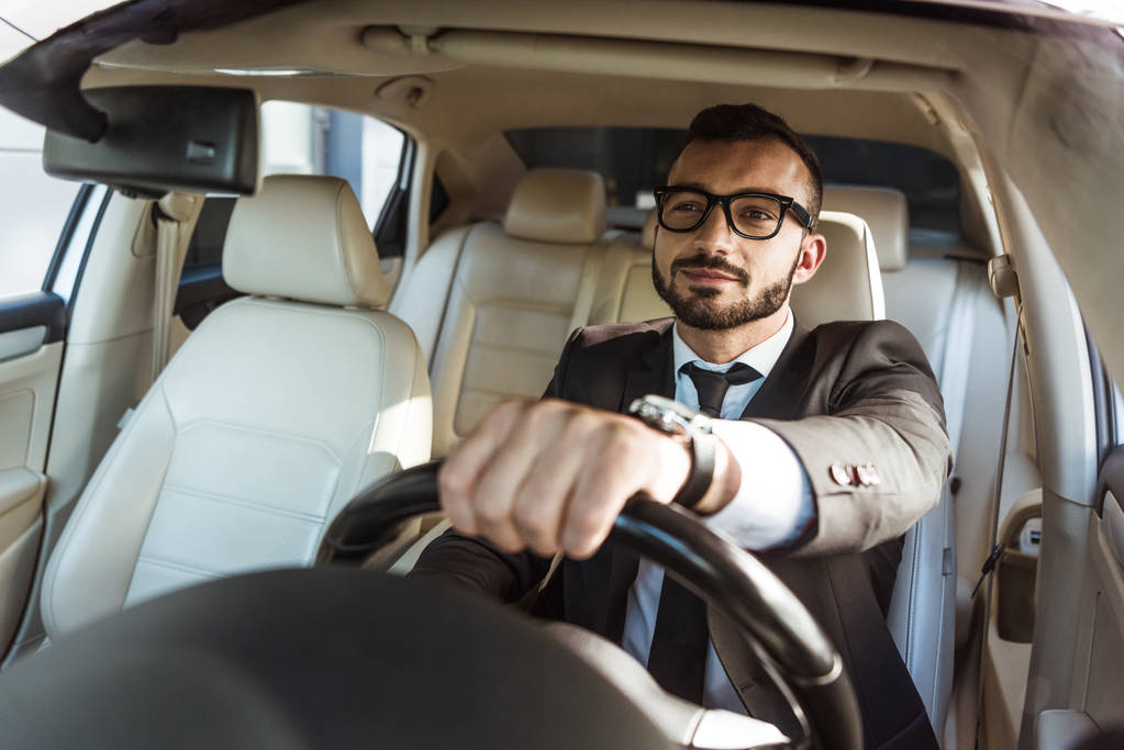 Driver in glasses driving a car