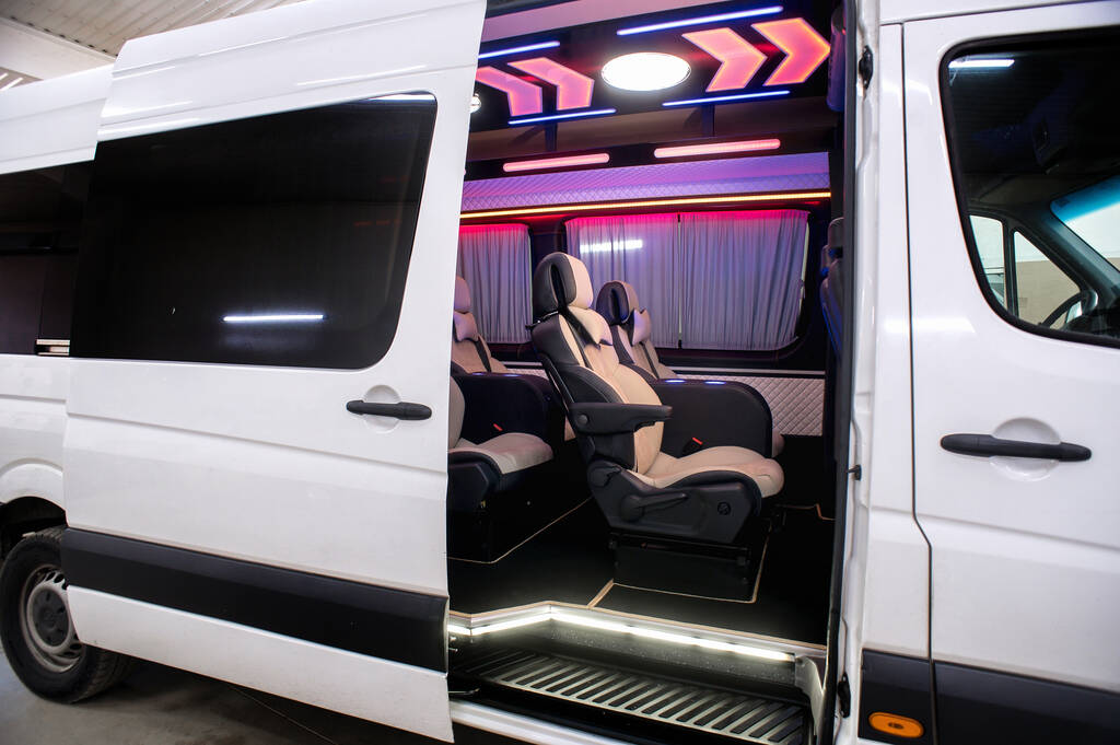 Comfortable interior of a passenger bus with soft seats. The design is made to order. Private covering of cars. Various elements of the bus interior.