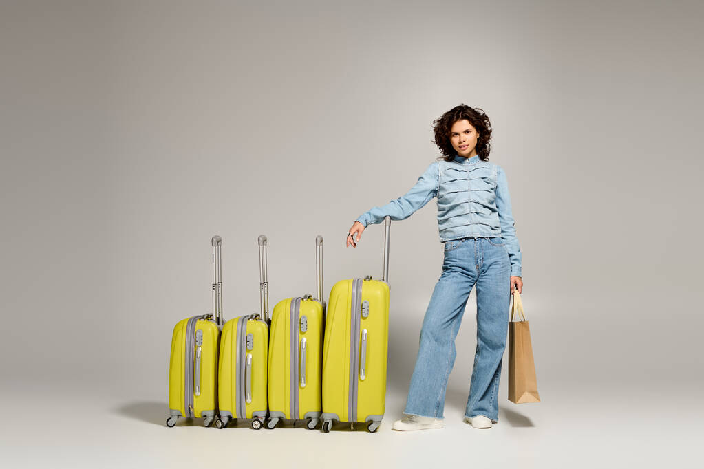 Woman standing beside vibrant yellow luggage