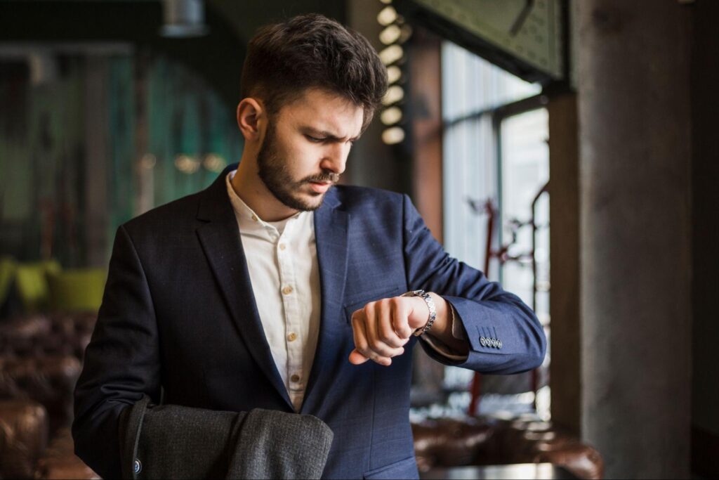  Man checking the time on his wristwatch