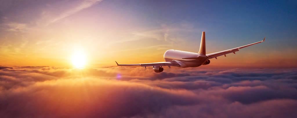 Commercial airplane flying above the clouds