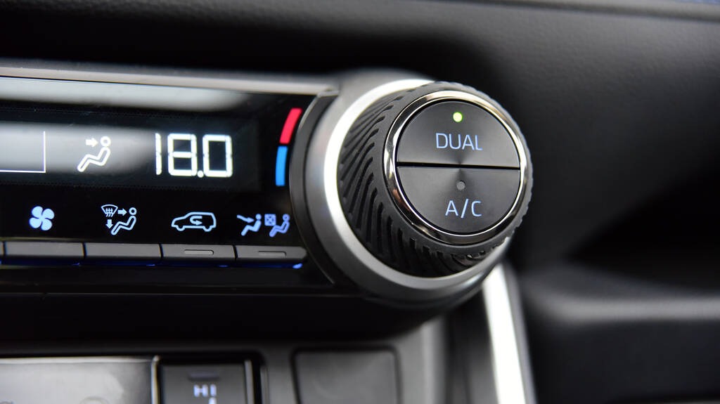 Interior of car dashboard buttons activating air-condition